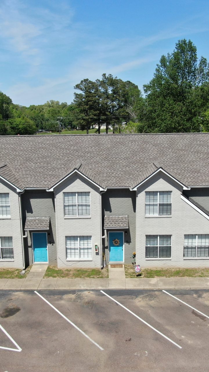 an aerial view of a parking lot with two apartment buildings at The Oaklawn Heights Apartments