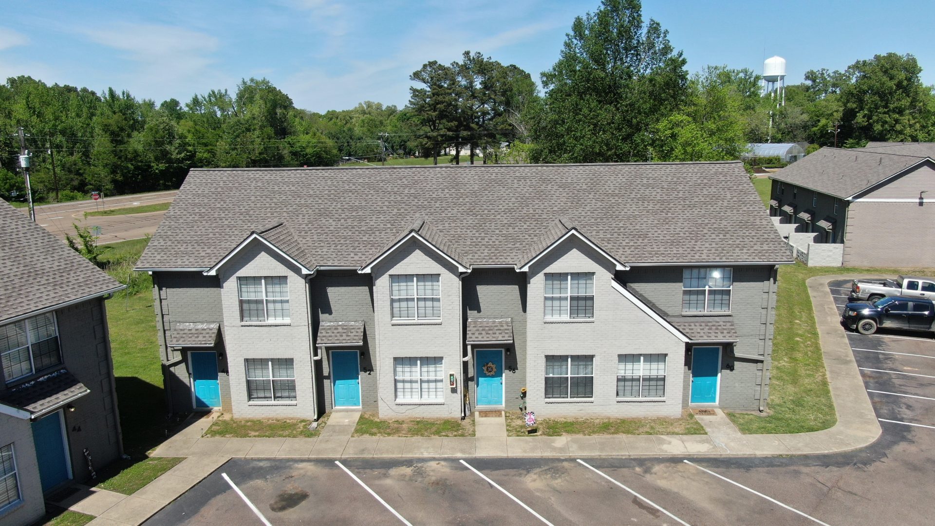 an aerial view of a parking lot with two apartment buildings at The Oaklawn Heights Apartments