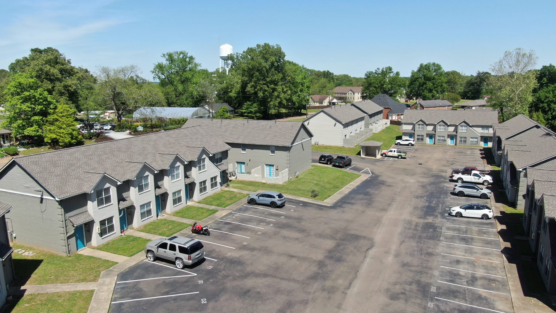 an aerial view of a parking lot with cars at The Oaklawn Heights Apartments