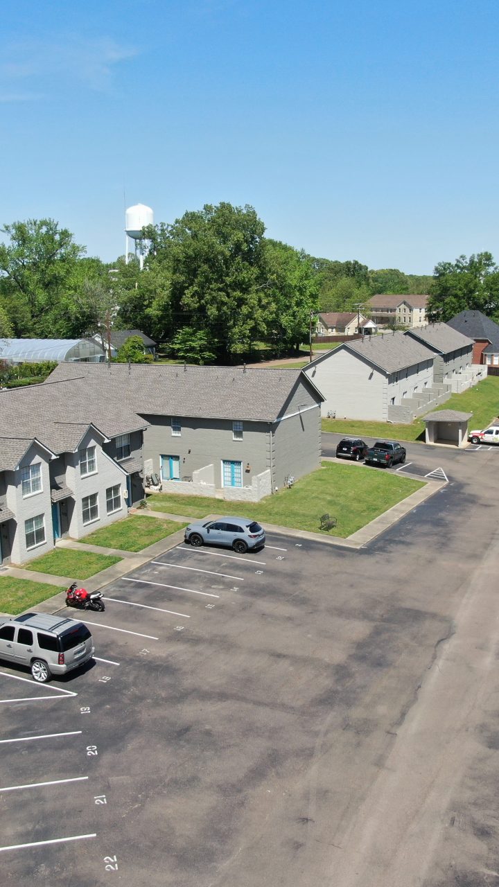 an aerial view of a parking lot with cars at The Oaklawn Heights Apartments